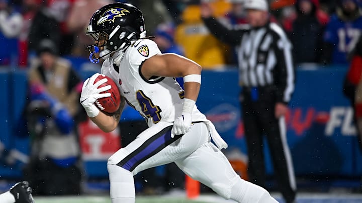 Jan 19, 2025; Orchard Park, New York, USA; Baltimore Ravens running back Keaton Mitchell (34) returns a kickoff against the Buffalo Bills in the fourth quarter of a 2025 AFC divisional round game against the Buffalo Bills at Highmark Stadium. Mandatory Credit: Mark Konezny-Imagn Images
