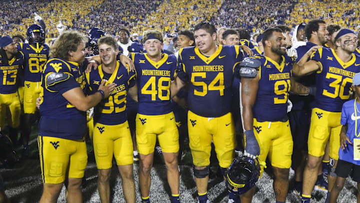 Sep 13, 2025; Morgantown, West Virginia, USA; West Virginia Mountaineers players celebrate after defeating the Pittsburgh Panthers at Milan Puskar Stadium. Mandatory Credit: Ben Queen-Imagn Images