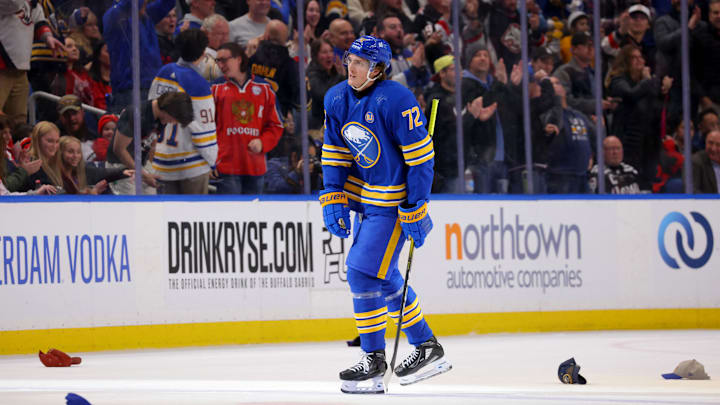 Fans throw hats on the ice to celebrate a hat trick by Buffalo Sabres right wing Tage Thompson (72): Timothy T. Ludwig-Imagn Images