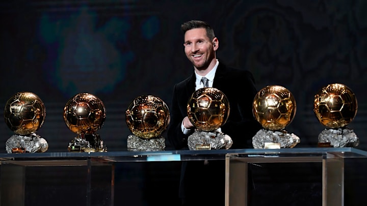 Lionel Messi posing with, at the time, his six Ballon d’Or trophies.