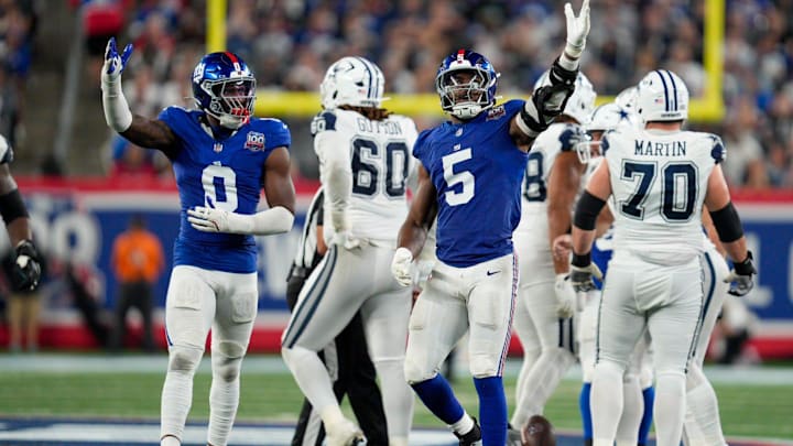 Sep 26, 2024; East Rutherford, NJ, US; New York Giants linebacker Brian Burns (0) and New York Giants linebacker Kayvon Thibodeaux (5) celebrate after sacking Dallas Cowboys quarterback Dak Prescott (4) at MetLife Stadium.  
