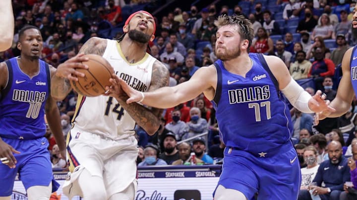 Dallas Mavericks guard Luka Doncic (77) fouls New Orleans Pelicans forward Brandon Ingram (14) during the second half at the Smoothie King Center. Mandatory Credit: Stephen Lew-Imagn Images Dallas Mavericks guard Luka Doncic (77) fouls New Orleans Pelicans forward Brandon Ingram (14) during the second half at the Smoothie King Center. Mandatory Credit: Stephen Lew-Imagn Images