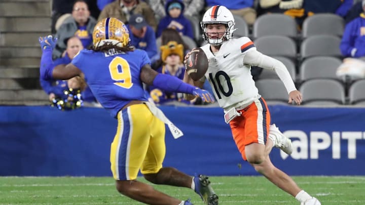 Nov 9, 2024; Pittsburgh, Pennsylvania, USA;  Virginia Cavaliers quarterback Anthony Colandrea (10) runs the ball against Pittsburgh Panthers linebacker Kyle Louis (9) during the third quarter at Acrisure Stadium. Mandatory Credit: Charles LeClaire-Imagn Images