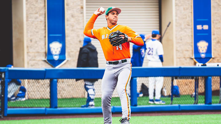 Miami Hurricanes third baseman Daniel Cuvet (14) against Pitt throwing to first baseman Todd Hudson (18)