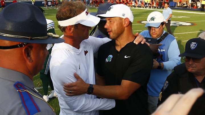 Sep 20, 2025; Oxford, Mississippi, USA; Mississippi Rebels head coach Lane Kiffin (left) and Tulane Green Wave head coach Jon Sumrall (right) embrace after the game at Vaught-Hemingway Stadium. Mandatory Credit: Petre Thomas-Imagn Images