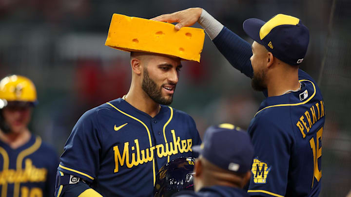 Jul 28, 2023; Atlanta, Georgia, USA; Milwaukee Brewers first baseman Abraham Toro (13) gets a cheesehead from right fielder Blake Perkins (16) after a three-run home run against the Atlanta Braves in the eighth inning at Truist Park. Mandatory Credit: Brett Davis-Imagn Images Jul 28, 2023; Atlanta, Georgia, USA; Milwaukee Brewers first baseman Abraham Toro (13) gets a cheesehead from right fielder Blake Perkins (16) after a three-run home run against the Atlanta Braves in the eighth inning at Truist Park. Mandatory Credit: Brett Davis-Imagn Images