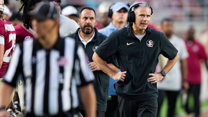 Florida State Seminoles head coach Mike Norvell talks on his headset as he coaches from the sideline. The Florida State Seminoles defeated the Virginia Tech Hokies 39-17 at Doak Campbell Stadium on Saturday, Oct. 7, 2023.