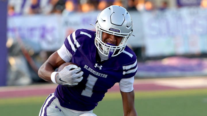 Bloomington South's Jalen Williams (1) slips a tackle by Bloomington North's Nathan Walker (2) during a high school football game Friday, Sept. 12, 2025.