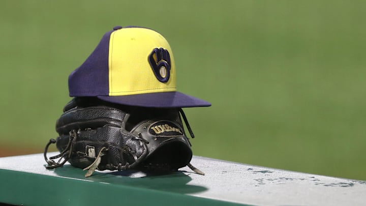 Jul 27, 2020; Pittsburgh, Pennsylvania, USA;  A Milwaukee Brewers hat and glove on the dugout rail against the Pittsburgh Pirates during the tenth inning at PNC Park.Milwaukee won 6-5 in eleven innings.  Mandatory Credit: Charles LeClaire-Imagn Images