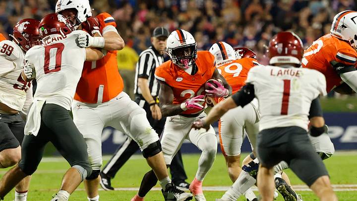 Oct 18, 2025; Charlottesville, Virginia, USA; Virginia Cavaliers running back Xavier Brown (20) carries the ball as Washington State Cougars linebacker Anthony Palano (0) and Cougars safety Tucker Large (1) defend during the first half at Scott Stadium. Mandatory Credit: Geoff Burke-Imagn Images Oct 18, 2025; Charlottesville, Virginia, USA; Virginia Cavaliers running back Xavier Brown (20) carries the ball as Washington State Cougars linebacker Anthony Palano (0) and Cougars safety Tucker Large (1) defend during the first half at Scott Stadium. Mandatory Credit: Geoff Burke-Imagn Images