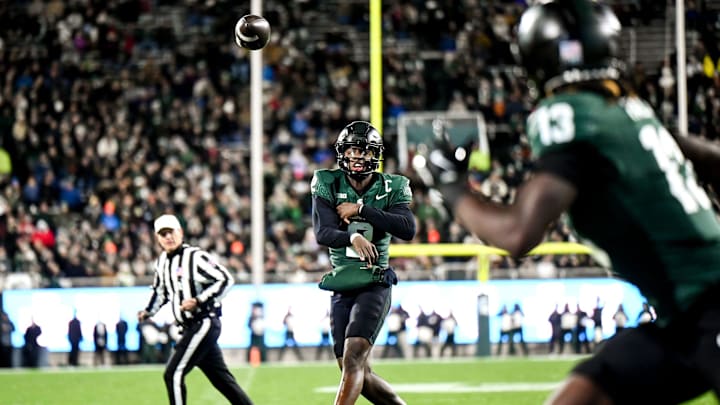 Michigan State's Aidan Chiles, left, throws the ball to Ademola Faleye during the second quarter in the game against Purdue on Friday, Nov. 22, 2024, at Spartan Stadium in East Lansing.