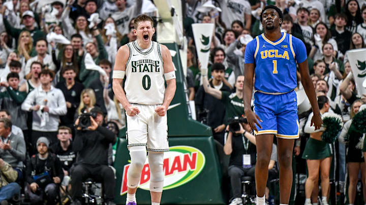 Michigan State's Jaxon Kohler, left, celebrates after making a 3-pointer against UCLA as the Bruins Xavier Booker, right, looks on during the first half on Tuesday, Feb. 17, 2026, at the Breslin Center in East Lansing.
