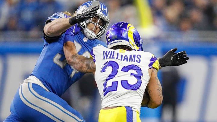 Detroit Lions linebacker Alex Anzalone tackles L.A. Rams running back Kyren Williams during the first half of the NFC wild-card game at Ford Field in Detroit on Sunday, Jan, 14, 2024.