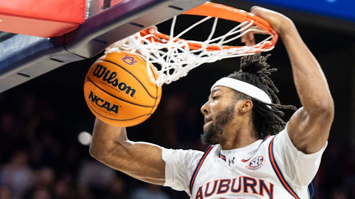 Auburn Tigers forward Chaney Johnson (31) dunks the ball as Auburn Tigers take on Arkansas Razorbacks at Neville Arena in Auburn, Ala., on Wednesday, Feb. 19, 2025. Auburn Tigers defeated Arkansas Razorbacks 67-60.