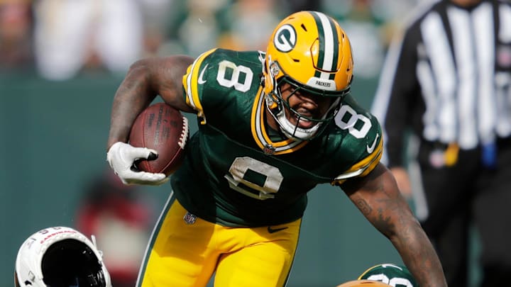 Arizona Cardinals defensive end Darius Robinson (56) loses his helmet tackling Green Bay Packers running back Josh Jacobs (8) on a first down run during their football game Sunday, October 13, 2024, at Lambeau Field in Green Bay, Wisconsin. Arizona Cardinals defensive end Darius Robinson (56) loses his helmet tackling Green Bay Packers running back Josh Jacobs (8) on a first down run during their football game Sunday, October 13, 2024, at Lambeau Field in Green Bay, Wisconsin.