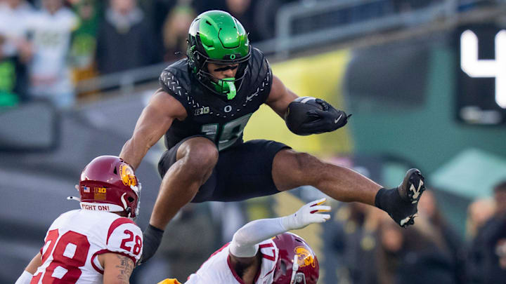 Oregon tight end Kenyon Sadiq hurdles over USC cornerback DeCarlos Nicholson as the Oregon Ducks host the USC Trojans on Nov. 22, 2025, at Autzen Stadium in Eugene, Oregon.