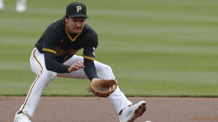 Apr 25, 2024; Pittsburgh, Pennsylvania, USA;  Pittsburgh Pirates second baseman Alika Williams (25) fields a ground ball for an out against Milwaukee Brewers first baseman Jake Bauers (not pictured) during the first inning at PNC Park. Mandatory Credit: Charles LeClaire-USA TODAY Sports