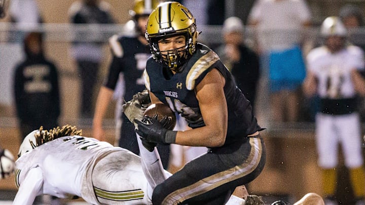Buchholz Bobcats Justin Williams (13) makes a turn upfield while avoiding tackles in the second half. The Buchholz Bobcats hosted the Oakleaf Knights at Citizens Field in Gainesville, FL on Friday, November 29 2024 in the Class 6A-Region 1 Final. The Bobcats defeated the Knights 25-19 and advance to the final four. [Doug Engle/Ocala Star Banner]