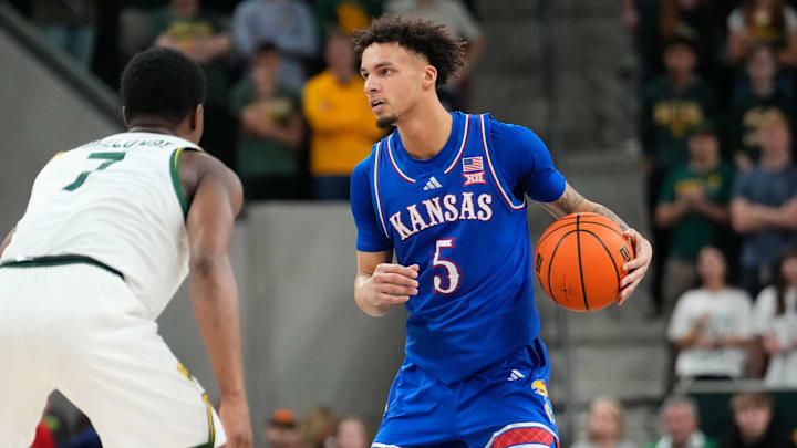 Feb 1, 2025; Waco, Texas, USA;  Kansas Jayhawks guard Zeke Mayo (5) controls the ball against Baylor Bears guard VJ Edgecombe (7) during the first half at Paul and Alejandra Foster Pavilion. Mandatory Credit: Chris Jones-Imagn Images