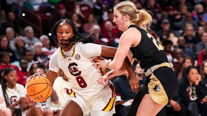 Dec 29, 2024; Columbia, South Carolina, USA; South Carolina Gamecocks forward Joyce Edwards (8) drives around Wofford Terriers forward Mia Flor (21) in the second half at Colonial Life Arena. Mandatory Credit: Jeff Blake-Imagn Images