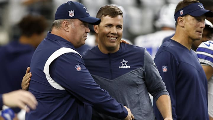 Dallas Cowboys head coach Mike McCarthy talks to offensive coordinator Kellen Moore before the game against the Cincinnati Bengals.