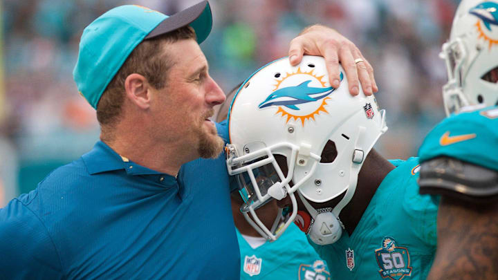 Miami Dolphins interim-head coach Dan Campbell, celebrates with players in the closing seconds of their game against the New England Patriots Sunday January 03, 2016 in Miami Gardens.