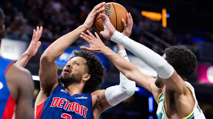 Jan 29, 2025; Indianapolis, Indiana, USA; Detroit Pistons guard Cade Cunningham (2) shoots the ball while Indiana Pacers guard Tyrese Haliburton (0) defends in the second half at Gainbridge Fieldhouse. Mandatory Credit: Trevor Ruszkowski-Imagn Images