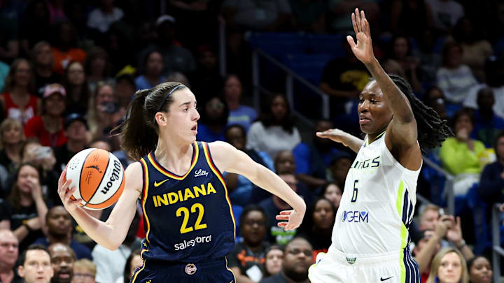 Natasha Howard defends Caitlin Clark during a 2024 game between the Fever and Wings.
