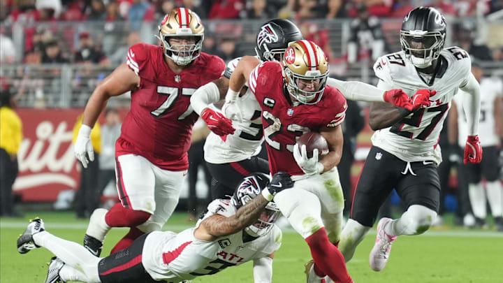 Oct 19, 2025; Santa Clara, California, USA; San Francisco 49ers running back Christian McCaffrey (23) carries the ball against Atlanta Falcons free safety Jessie Bates (3) during the third quarter at Levi's Stadium. Mandatory Credit: Darren Yamashita-Imagn Images