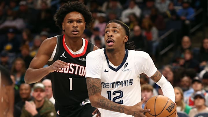 Jan 9, 2025; Memphis, Tennessee, USA; Memphis Grizzlies guard Ja Morant (12) drives to the basket as Houston Rockets forward Amen Thompson (1) defends during the first quarter at FedExForum. Mandatory Credit: Petre Thomas-Imagn Images Jan 9, 2025; Memphis, Tennessee, USA; Memphis Grizzlies guard Ja Morant (12) drives to the basket as Houston Rockets forward Amen Thompson (1) defends during the first quarter at FedExForum. Mandatory Credit: Petre Thomas-Imagn Images