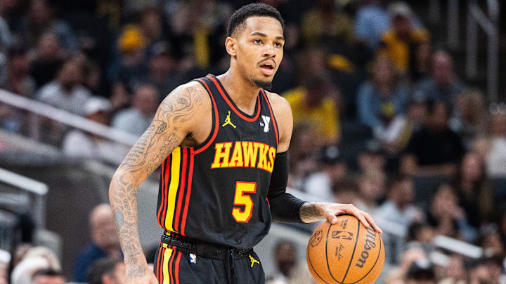 Apr 14, 2024; Indianapolis, Indiana, USA; Atlanta Hawks guard Dejounte Murray (5) dribbles the ball while Indiana Pacers guard Ben Sheppard (26) defends in the second half at Gainbridge Fieldhouse. Mandatory Credit: Trevor Ruszkowski-USA TODAY Sports