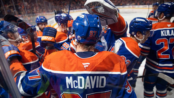 Connor McDavid and Edmonton Oilers celebrating McDavid's 1000 point.