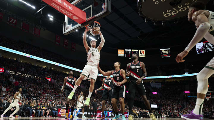 Jan 31, 2024; Portland, Oregon, USA; Milwaukee Bucks center Brook Lopez (11) dunks the basketball during the first half against Portland Trail Blazers guard Malcolm Brogdon (11) and center Deandre Ayton (2) at Moda Center. Mandatory Credit: Troy Wayrynen-USA TODAY Sports