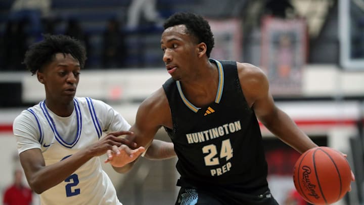 Huntington Prep guard Darryn Peterson, right, drives to the basket against Richmond Heights guard Demaris Winters Jr. during the first half of a basketball game in the Canton Play-By-Play Classic at Canton Memorial Field House, Saturday, Feb. 17, 2024, in Canton, Ohio.