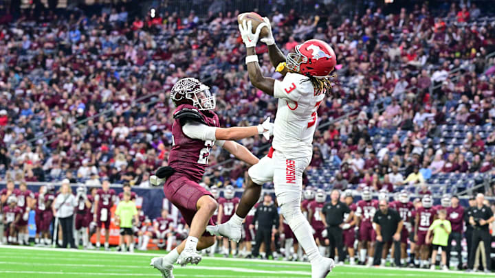 Receiver Deion Deblanc of North Shore (Texas) makes a leaping touchdown catch over a Cy-Fair defender in the UIL Class 6A Division 1 playoff game at NRG Stadium in Houston.