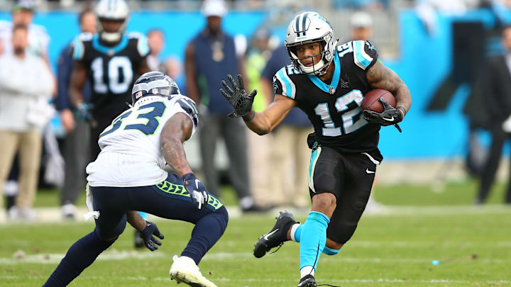 Nov 25, 2018; Charlotte, NC, USA; Carolina Panthers wide receiver DJ Moore (12) runs after a reception in the fourth quarter against Seattle Seahawks free safety Tedric Thompson (33) at Bank of America Stadium. Mandatory Credit: Jeremy Brevard-Imagn Images