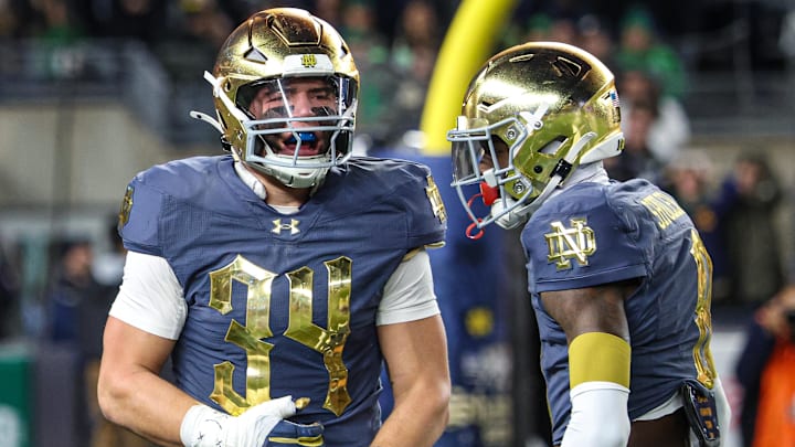 Nov 23, 2024; New York, New York, USA; Notre Dame Fighting Irish linebacker Drayk Bowen (34) celebrates a defensive stop with safety Adon Shuler (8) during the first half against the Army Black Knights at Yankee Stadium. Mandatory Credit: Vincent Carchietta-Imagn Images
