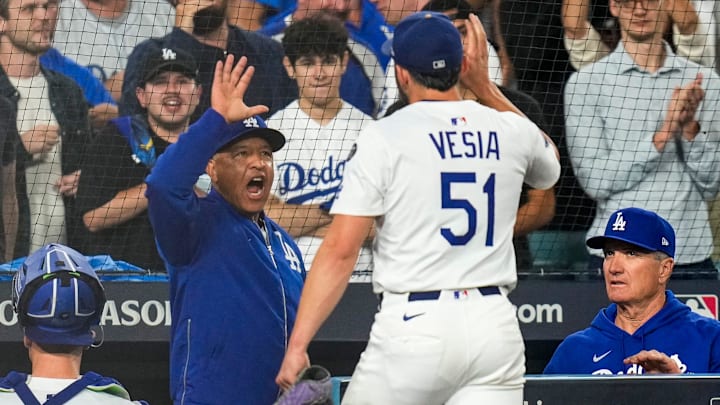 Los Angeles Dodgers manager Dave Roberts high fives relief pitcher Alex Vesia (51) after getting out of the eighth inning of the MLB National League Wild Card Game 2 between the Los Angeles Dodgers and the Cincinnati Reds at Dodger Stadium in Los Angeles on Wednesday, Oct. 1, 2025. The Reds were eliminated from the postseason with an 8-4 loss to the reining World Series Champions La Dodgers. Los Angeles Dodgers manager Dave Roberts high fives relief pitcher Alex Vesia (51) after getting out of the eighth inning of the MLB National League Wild Card Game 2 between the Los Angeles Dodgers and the Cincinnati Reds at Dodger Stadium in Los Angeles on Wednesday, Oct. 1, 2025. The Reds were eliminated from the postseason with an 8-4 loss to the reining World Series Champions La Dodgers.