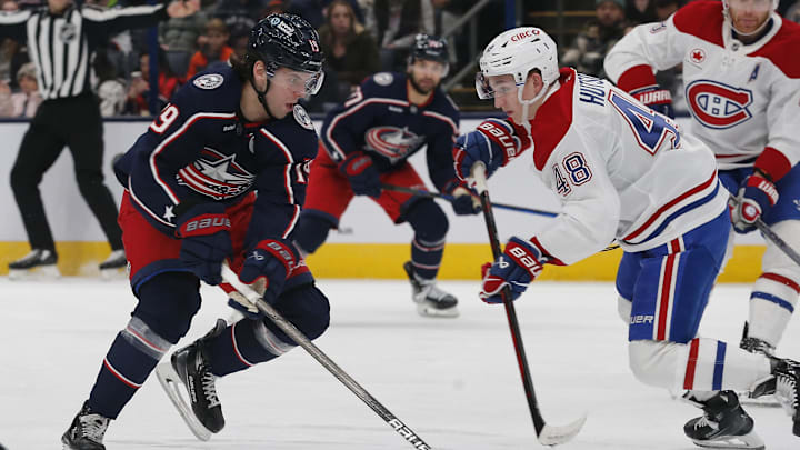 Dec 23, 2024; Columbus, Ohio, USA; Columbus Blue Jackets center Adam Fantilli (19) chases after a loose puck as Montreal Canadiens defenseman Lane Hutson (48) defends during the second period at Nationwide Arena. Mandatory Credit: Russell LaBounty-Imagn Images