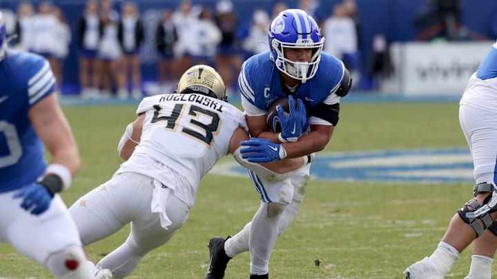 Nov 29, 2025; Provo, Utah, USA; BYU Cougars running back LJ Martin (4) runs against UCF Knights linebacker Cole Kozlowski (43) during the second half at LaVell Edwards Stadium. Mandatory Credit: Rob Gray-Imagn Images Nov 29, 2025; Provo, Utah, USA; BYU Cougars running back LJ Martin (4) runs against UCF Knights linebacker Cole Kozlowski (43) during the second half at LaVell Edwards Stadium. Mandatory Credit: Rob Gray-Imagn Images