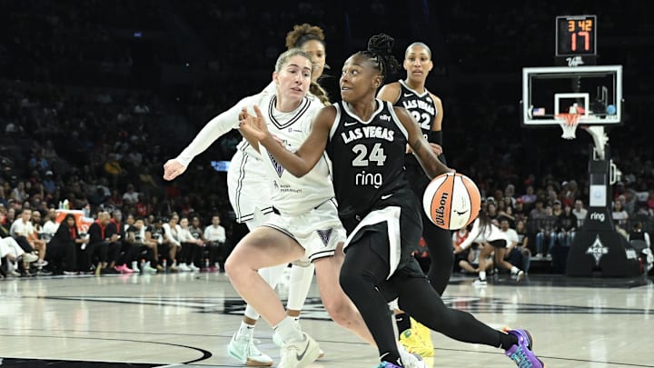 Aug 3, 2025; Las Vegas, Nevada, USA; Las Vegas Aces guard Jewell Loyd (24) drives past Golden State Valkyries guard Kate Martin (20) in the first quarter at Michelob Ultra Arena. 
