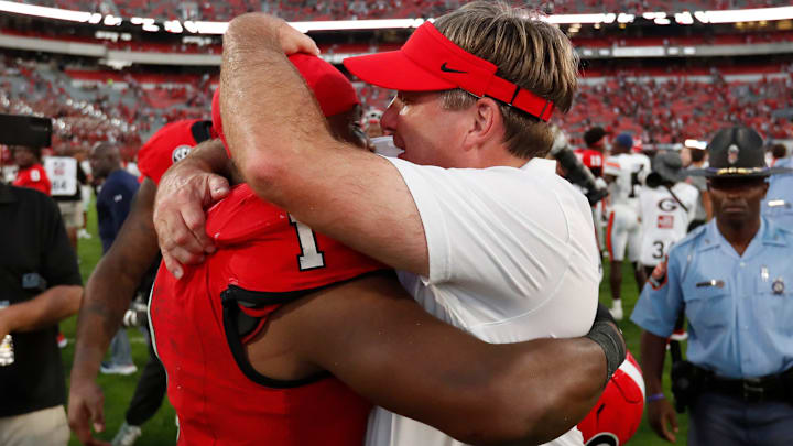 Georgia head coach Kirby Smart celebrates with Georgia running back Trevor Etienne (1) after winning a NCAA college football game against Auburn in Athens, Ga., on Saturday, Oct. 5, 2024. Georgia won 31-13.