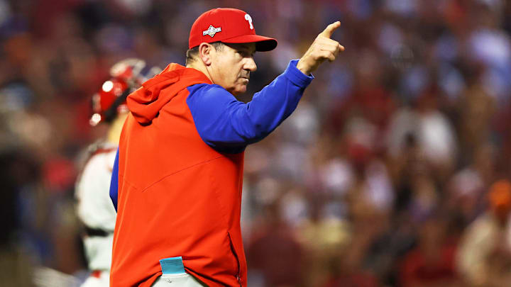Oct 20, 2023; Phoenix, Arizona, USA; Philadelphia Phillies manager Rob Thomson signals to the bullpen during the seventh inning against the Arizona Diamondbacks in game four of the NLCS for the 2023 MLB playoffs at Chase Field.