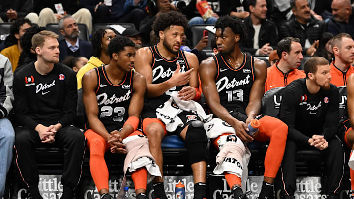 Mar 22, 2024; Detroit, Michigan, USA; Detroit Pistons guard Cade Cunningham (2) (center) talks with guard Jaden Ivey (23) (left) and  center James Wiseman (13) on the bench in the first quarter of their game against the Boston Celtics at Little Caesars Arena. Mandatory Credit: Lon Horwedel-Imagn Images