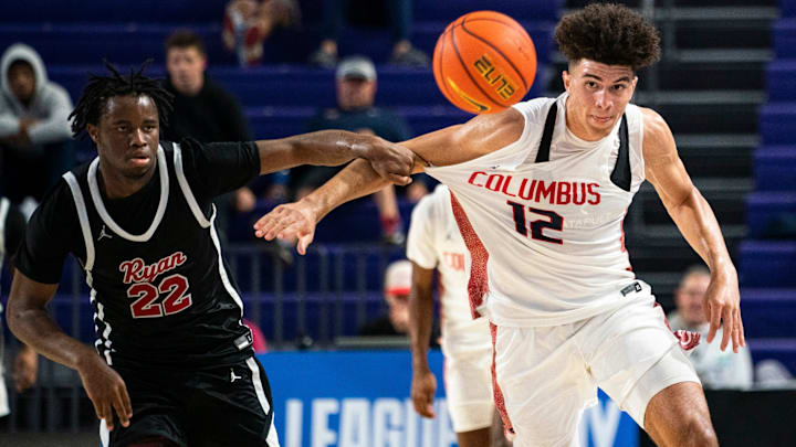 Columbus Explorers forward Cameron Boozer (12) and Archbishop Ryan Raiders forward Jaden Murray (22) chase the ball during the third quarter of a game during the 50th annual City of Palms Classic at Suncoast Credit Union Arena in Fort Myers on Tuesday, Dec. 19, 2023.