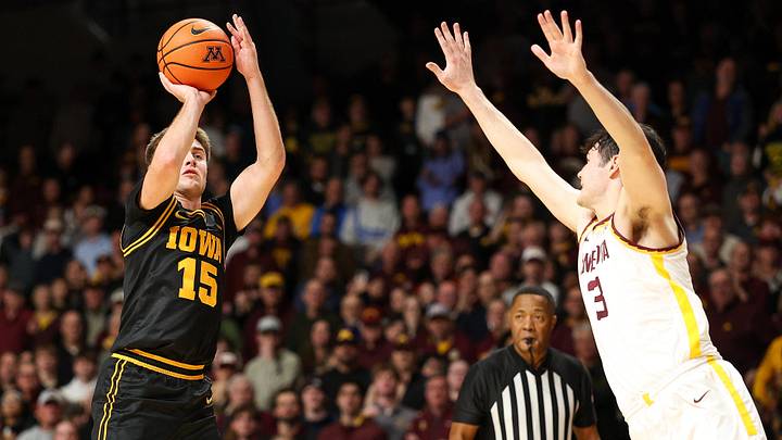 Jan 6, 2026; Minneapolis, Minnesota, USA; Iowa Hawkeyes guard Brendan Hausen (15) shoots as Minnesota Golden Gophers forward Bobby Durkin (3) defends during the second half at Williams Arena. Mandatory Credit: Matt Krohn-Imagn Images
