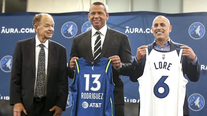 Sep 27, 2021; Minneapolis, MN, USA; Current owner Glen Taylor and limited partners and alt-governors for the Minnesota Timberwolves Alex Rodriguez and Mark Lore hold up jerseys after answering questions at a press conference at media day. Sep 27, 2021; Minneapolis, MN, USA; Current owner Glen Taylor and limited partners and alt-governors for the Minnesota Timberwolves Alex Rodriguez and Mark Lore hold up jerseys after answering questions at a press conference at media day.