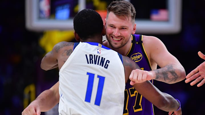 Feb 25, 2025; Los Angeles, California, USA; Los Angeles Lakers guard Luka Doncic (77) reacts with Dallas Mavericks guard Kyrie Irving (11) during the first quarter at Crypto.com Arena. 