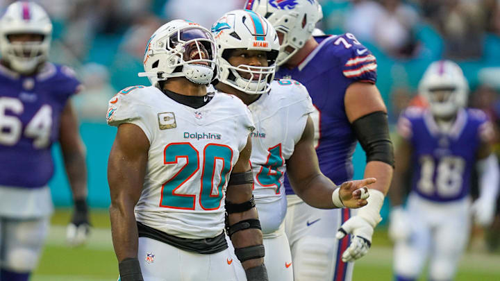 Miami Dolphins linebacker Jordyn Brooks (20) and defensive tackle Jordan Phillips (94) celebrate a fourth-down stop against the Buffalo Bills during the fourth quarter at Hard Rock Stadium. 