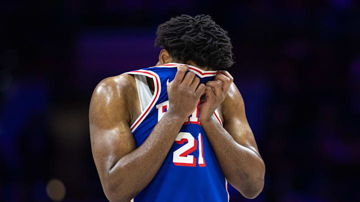 Feb 20, 2025; Philadelphia, Pennsylvania, USA; Philadelphia 76ers center Joel Embiid (21) wipes his face during a break in the third quarter against the Boston Celtics at Wells Fargo Center. Mandatory Credit: Bill Streicher-Imagn Images